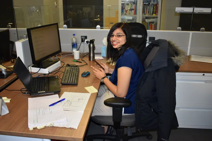 Jumana Bohra working at her desk as a software engineer at Bombardier